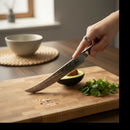 DDR BBQ Supply Spaceman Knives Damascus steel butcher scimitar slicing an avocado on a wooden cutting board