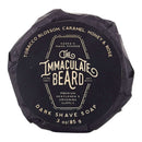 DDR BBQ Supply Immaculate Beard Dark Shave Soap puck wrapped in black paper with elegant white typography.