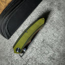 DDR BBQ Supply Spaceman Knives Galatea folding pocket knife with an olive green G10 handle and stainless steel blade.