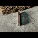 DDR BBQ Supply Spaceman Knives Galatea folding pocket knife in a closed position against a textured stone background