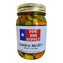 DDR BBQ Supply Garden Medley Pickles Pint – 16 oz comes in a glass jar with a red, white, and blue label featuring a white star and contains zesty, crunchy pickled vegetables. Brand: DDR BBQ Supply. Net weight: 16 oz (454g).
