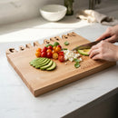 A person slices an avocado on the Words With Boards Seriously Gluten Free Personalized Cutting Board (Small 9.5" x 12.5") by Words with Boards, LLC, featuring cut-out and engraved text, ideal for gluten free cooking on a marble kitchen counter.