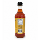 A clear bottle with amber liquid, yellow label, black cap, and visible nutrition facts panel contains Guenther Apiary Apple Cider Vinegar with Honey & “Mother.” The upright bottle shows a barcode, ingredients, and the Guenther Apiary brand on a white background.