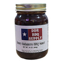 DDR BBQ Supply Honey Habanero BBQ Sauce – 16 oz is a glass jar of sweet and spicy BBQ sauce featuring a Texas flag label and DDR BBQ Supply’s address at the bottom.