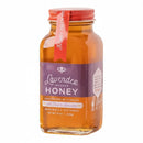 An 8 oz glass jar of Honey Truck Co Lavender Infused Honey, featuring a calming honey harvested in Florida. The jar is sealed with a red lid and has a purple label that reads "Lavender Infused Honey" from the brand Honey Truck Co.