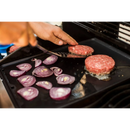 DDR BBQ Supply Napoleon reversible cast iron griddle cooking burger patties and sliced red onions on a grill