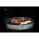 DDR BBQ Supply Napoleon cast iron reversible griddle on a 22-inch charcoal grill cooking sausages, eggs, and peppers.