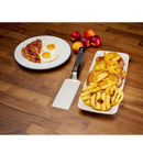 DDR BBQ Supply Napoleon griddle spatula with black handle next to a plate of breakfast food on a wooden table