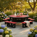 The Kanyon Living Poly Picnic Table Octagonal Red & Black, with matching benches, sits on a stone patio with blooming hydrangeas. This durable outdoor seating holds a pitcher, glasses, and flowers as sunlight filters through the trees.
