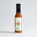 A bottle of Culture Hot Sauce Para Mis Amigos from Culture Hot Sauce, distinguished by its green handprint and red text label, stands upright against a plain light background. This authentic sauce delivers the bold flavors of Mexican-style hot sauce with a vibrant base of serrano chili.