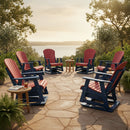 Six Kanyon Living Adirondack Poly Glider Swivel Chairs in red and blue provide outdoor comfort on a stone patio overlooking water. These eco-friendly chairs are paired with small tables and drinks, surrounded by greenery under the sun.