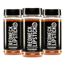 DDR BBQ Supply Redneck Lipstick 3-pack of smoky, sweet, and spicy BBQ seasoning rub in clear plastic bottles.