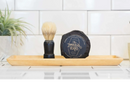 DDR BBQ Supply shave soap puck and wooden handle brush on a tray in a bathroom setting
