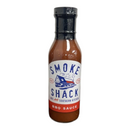 DDR BBQ Supply Brushfire Farms Smoke Shack BBQ sauce bottle with a white label featuring a Texas shack illustration.