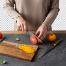 A person slices a red tomato with a knife from the Steelport Knife Co. 3-Piece Essential Set on a dark countertop, next to a wooden cutting board holding yellow tomato slices and a yellow tomato. Another knife from the American-made Steelport Knife Co. collection and fresh basil leaves are also visible.