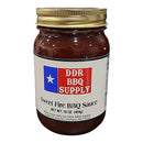 A 16 oz glass jar of DDR BBQ Supply Sweet Fire BBQ Sauce with a gold lid. The label has a blue and red design with a white star, displaying the product name, brand, weight, and company details.