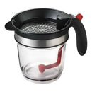 DDR BBQ Supply XL gravy fat separator with built-in strainer, clear measuring cup, and red bottom-release trigger.