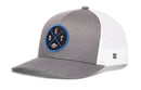 Introducing the Haka Hat Detroit Football Trucker Hat | Black DET X Snapback—a gray and white Michigan hat by Haka Hat, featuring a round blue and black patch on the front with crossed lines, the letters D, E, T, and a small football in the center. This classic snapback design offers a mesh back and curved brim for timeless trucker style.