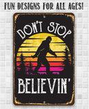 The Lone Star Art "Don't Stop Believing Big Foot" metal sign features a retro Bigfoot silhouette before a sunset and trees, with the phrase "DON'T STOP BELIEVIN"—a great Sasquatch gift or cool cabin decor for all ages.