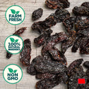 Rico Rico Chipotle Morita Dried Chiles – Smoky & Medium Heat Mexican Peppers rest on a wooden surface, showcasing richly flavored, authentic jalapeño peppers. Three circular labels—Farm Fresh, 100% Natural Ingredients, and Non GMO—are accented with green leaf graphics, highlighting this Rico Rico product as a must-have authentic Mexican ingredient for your kitchen.