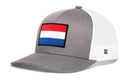 Gray and white Haka Hat Netherlands Flag International Trucker Hat featuring a rectangular patch of the Dutch flag on the front.