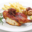 A plate featuring spicy grilled chicken seasoned with The Spice Lab Organic Granulated Onion, accompanied by French fries, roasted potatoes, and garnished with a sprig of rosemary, served on a white background.