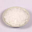 A small, round white bowl filled with large, pyramid-shaped crystals of The Spice Lab Cyprus White Large Flake Sea Salt sits on a light surface.