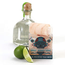 Arranged on a white background, The Spice Lab Himalayan Salt Tequila Shooters - 8 Pack by The Spice Lab is displayed alongside a bottle of tequila and a lime with one wedge cut, making it ideal for crafting your own tequila party set or enjoying stylish Himalayan salt tequila shooters.