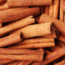 A close-up of The Spice Lab Organic Cinnamon Sticks, piled together to showcase their rough texture and rich brown color—perfect for adding warmth to chai or mulled wine.