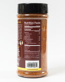 A clear plastic spice jar with a black lid, from Chiles and Smoke, displays nutrition facts and ingredients on its back label. The seasoning blend inside, Chiles & Smoke Sedona Sand Fiesta Seasoning, is red-orange in color and features spices like paprika, guajillo chili, and dehydrated garlic. This Southwest BBQ-inspired blend works as an all-purpose grilling seasoning—perfect for adding bold, smoky flavor to your favorite dishes.