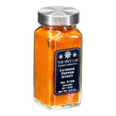 A clear glass jar with a silver lid, filled with vivid orange X-Hot ground cayenne pepper. The black label displays “The Spice Lab Cayenne Pepper X-Hot Ground,” 2.2 oz.