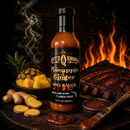 A bottle of Scott’s Smoked Q Pineapple Ginger Sauce Tropical Glaze, Marinade & Dip sits by ginger, pineapple, ribs, and a brush near a fiery grill—your ideal tropical BBQ companion from Scott’s Smoked Q.