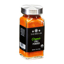 A glass jar of The Spice Lab Organic Chili Powder features a metal lid and a black label displaying the product name and weight (1.8 oz/51g), while vibrant orange-red spice is visible inside. Ideal for intensifying Mexican seasonings or crafting spicy rubs.