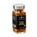 A clear glass jar with a silver lid contains The Spice Lab Organic Crushed Red Pepper Flakes, making it ideal for Italian dishes or as a spicy pizza topping. The jar holds 1.4 oz (39g) and features a black label that displays the brand, The Spice Lab.