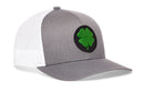 The Haka Hat Four Leaf Clover Trucker Hat by Haka Hat features a stylish gray and white mesh design with a prominent green four-leaf clover emblem on the front, making this St. Patrick’s Day snapback the perfect accessory for any casual outing.