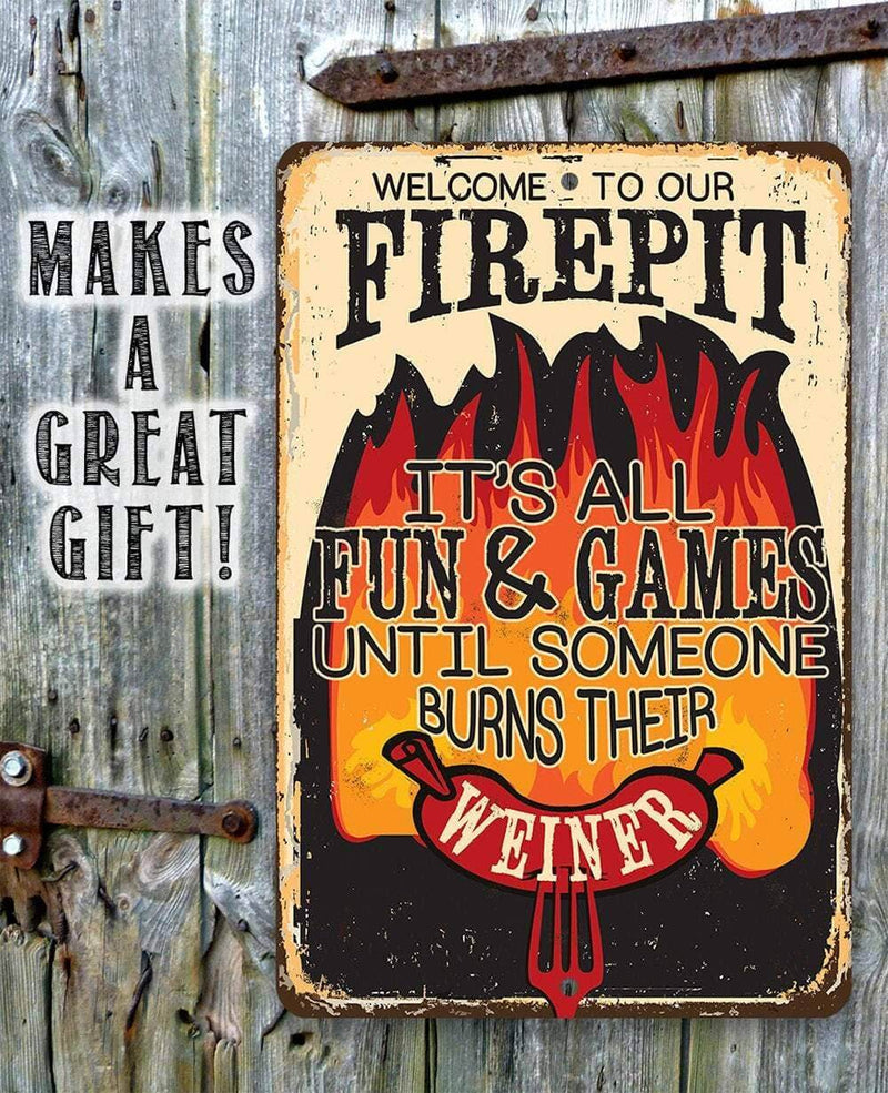 Metal sign with humorous text about a firepit on a wooden background