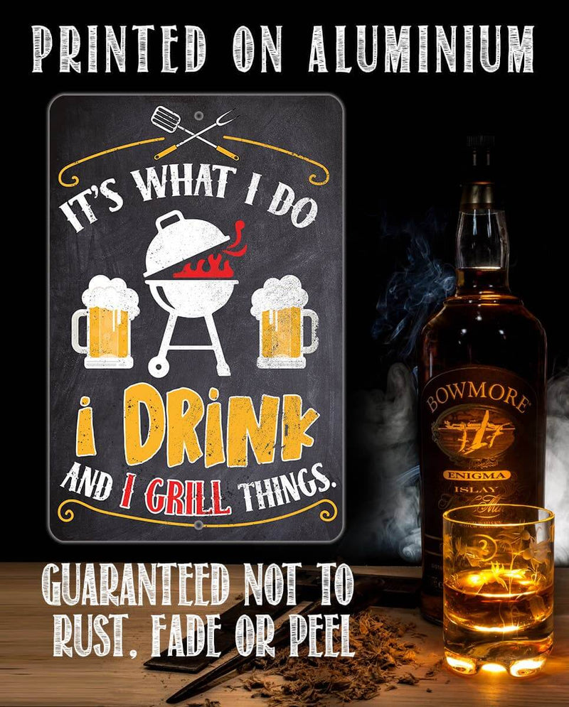 Aluminium sign with grill and beer design next to a bottle of Bowmore whisky.