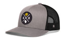 Show off your Wisconsin pride with the Haka Hat Green Bay Trucker Hat | Black GB Cheese X Snapback. This gray and black Haka Hat features a breathable mesh back and a round front patch displaying a yellow lion, crossed lines, the letters G and B, and an outline of Wisconsin.
