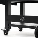 Close-up of the lower section of a Green Mountain Grills Peak Prime 2.0 pellet grill cart with caster wheels, a perforated shelf, and a mountain logo—ideal support for your Wi-Fi controlled Green Mountain Grills unit. Plain white background.