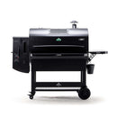 The Green Mountain Grills Peak Prime 2.0 is a black Wi-Fi pellet grill and smoker with a large cooking area, left control panel, top chimney, right side tray, lower storage shelf, and wheels for easy mobility.