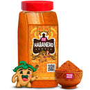 A Rico Rico Habanero Chile Powder Shaker, branded by Rico Rico, is shown as a plastic container adorned with an illustrated smiling jalapeño mascot and flaming accents on the label. In front of the shaker sits a small bowl filled with the vibrant orange-red hot spice, capturing the lively essence of authentic Mexican flavors.