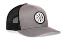 The Haka Hat PNW Trucker Hat (Gray-Black PNW X Snapback) features a round patch with a tree, arrow, and the letters PNW on front, plus black mesh back and adjustable snapback closure for a comfortable fit.