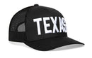 The Haka Hat Texas Trucker Hat is a classic black mesh snapback featuring bold 3D-embroidered TEXAS lettering on the front—a signature Haka Hat style.