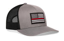 The Haka Hat Thin Red Line Trucker Hat | Gray-Black Fire Snapback features a gray front, black mesh back, a patch with a black-and-white American flag and red stripe, plus a comfort-fit sweatband for all-day wear.