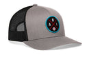 The Haka Hat Arizona Trucker Hat features a gray front, black mesh back, snapback closure, and a round blue-edged patch with "ARI" and a baseball graphic. This ARI X Baseball Snapback is from Haka Hat.