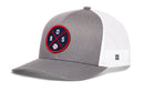 The Haka Hat Boston Trucker Hat features a gray and white design, mesh back, snapback closure, and a round navy patch with red border, crossed red lines, "BOS," and a small baseball graphic at the center.