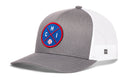 The Haka Hat Chicago Trucker Hat is a gray and white snapback with a mesh back, featuring a round blue front patch with red and white accents, the letters CHI, and a baseball graphic.