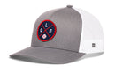 The Haka Hat Cleveland Trucker Hat is a gray and white snapback with a mesh back and a front navy patch featuring CLE letters and a baseball graphic—classic style from Haka Hat.