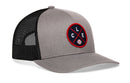 The Haka Hat Cleveland Trucker Hat, also known as the CLE X Baseball Snapback, features grey mesh and a circular patch with a baseball and the letters L, C, and E—offering stylish comfort for devoted fans.