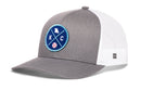 The Haka Hat Kansas City Trucker Hat by Haka Hat is a gray and white snapback with a mesh back and a round blue front patch featuring KC, a map outline, and a small baseball icon.